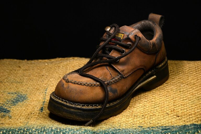 Image displays a workboot fully clean and re stitched over a yellow towel.